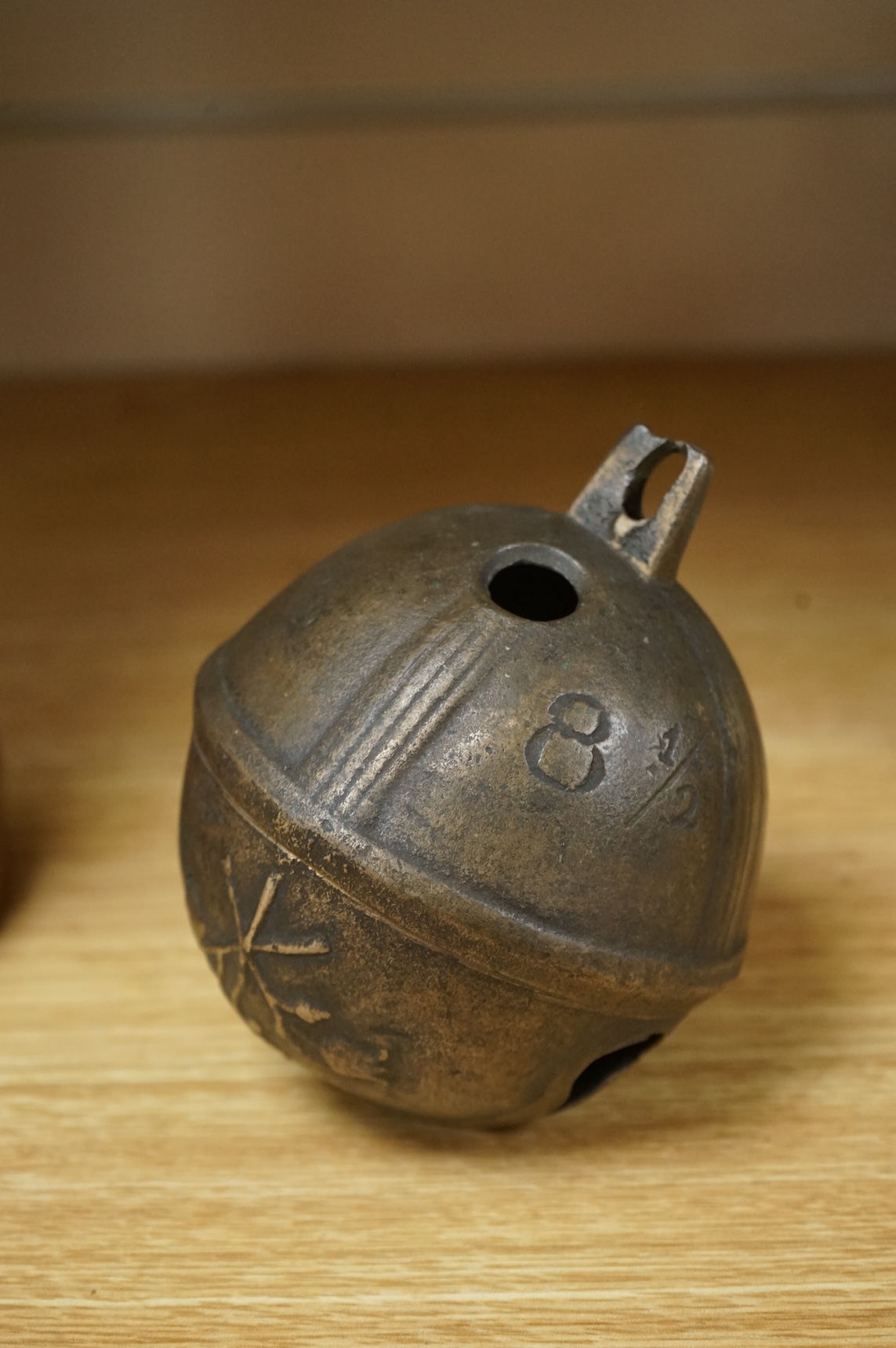 A 19th century livestock crotal bell engraved 8 1/2, 12cm wide